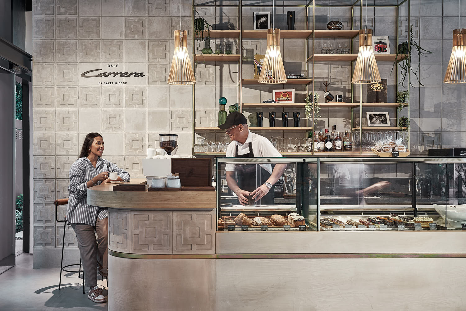 Porsche showroom café experience with women relaxing over a gourmet breakfast.