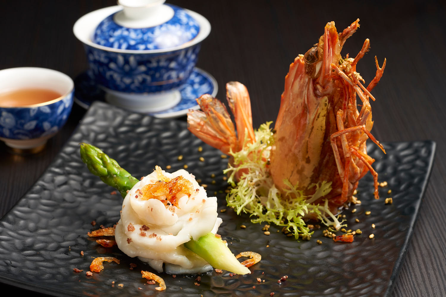 Gourmet dish featuring sautéed prawns paired with tender asparagus spears.