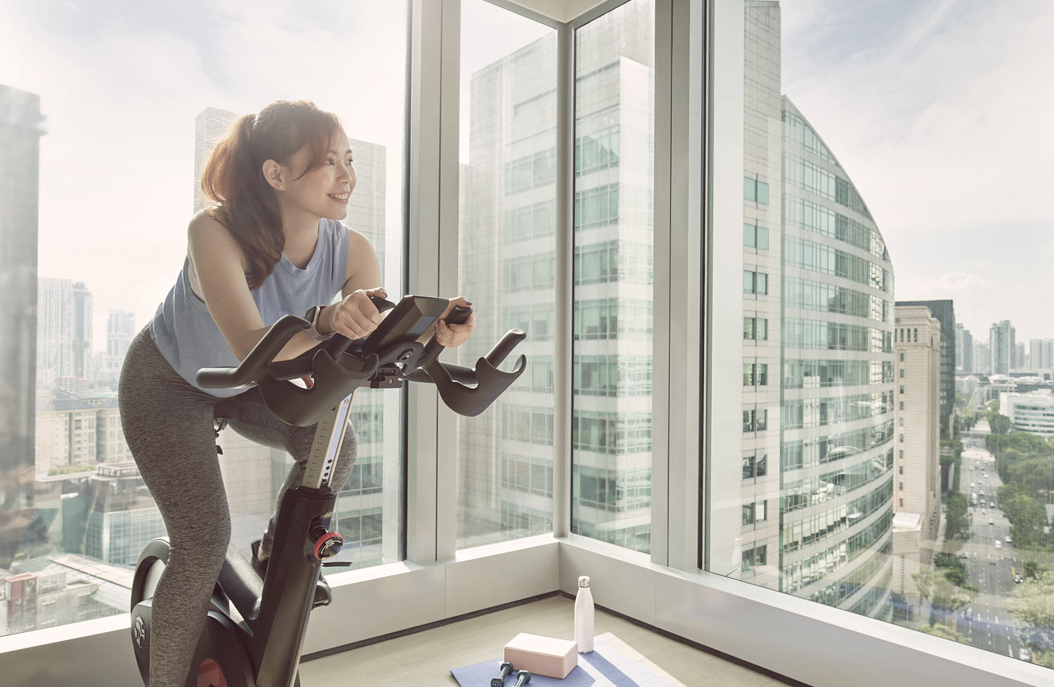 Exclusive gym setup with stunning balcony views at a luxury hotel.