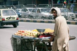 A fruit seller in Rawalpindi, Pakistan, takes a second glance at a passing foreigner, August 2010.