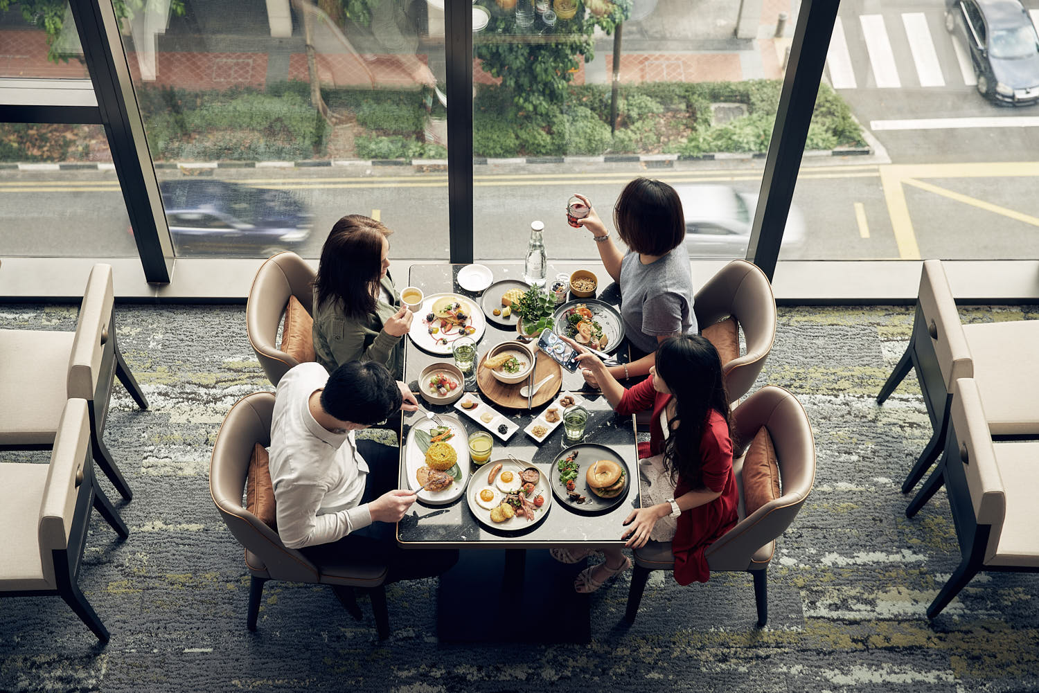 Top down shot of diners enjoying their meals and sharing joyful moments in the evening.