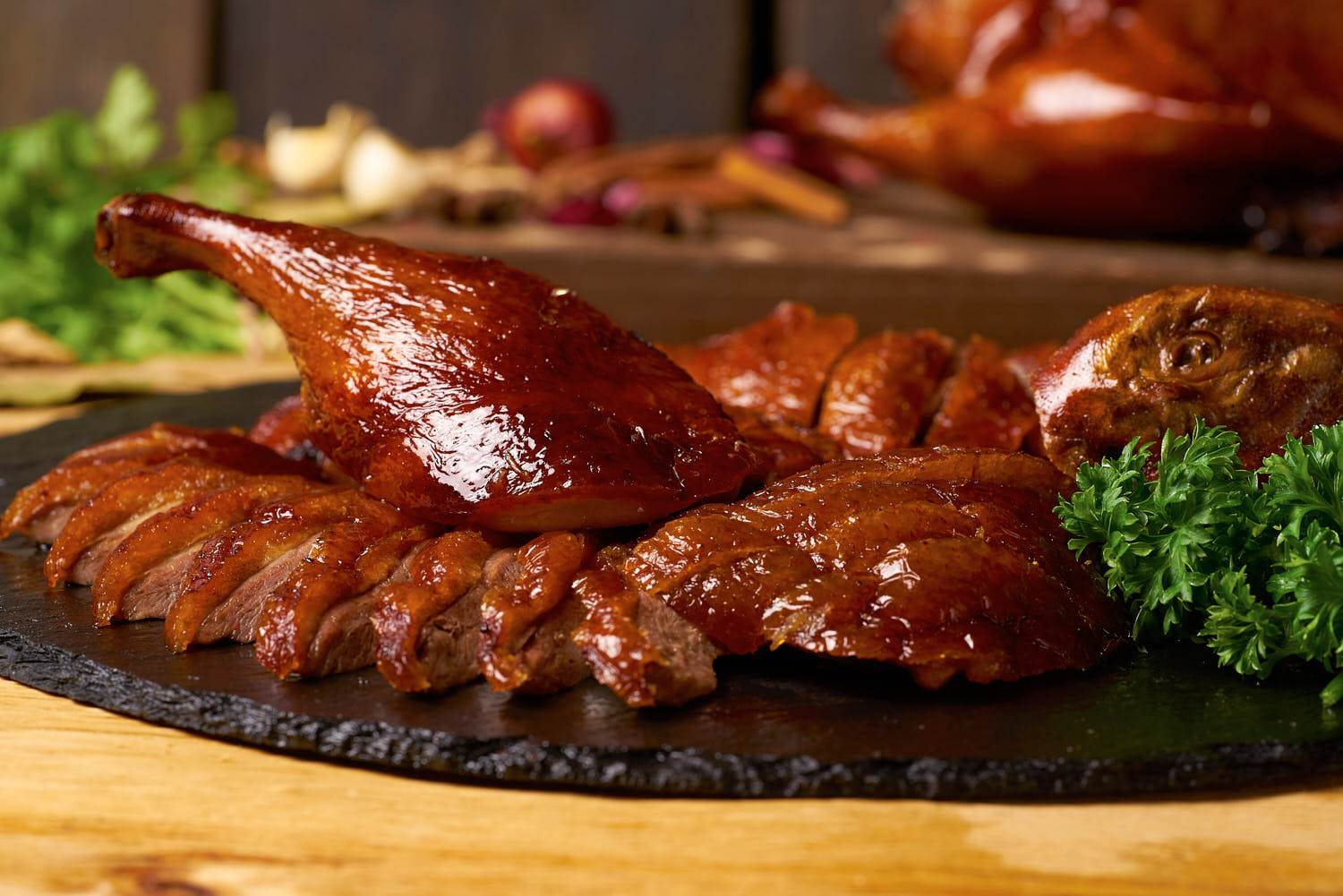 Crispy roast duck with golden-brown skin served on a platter.