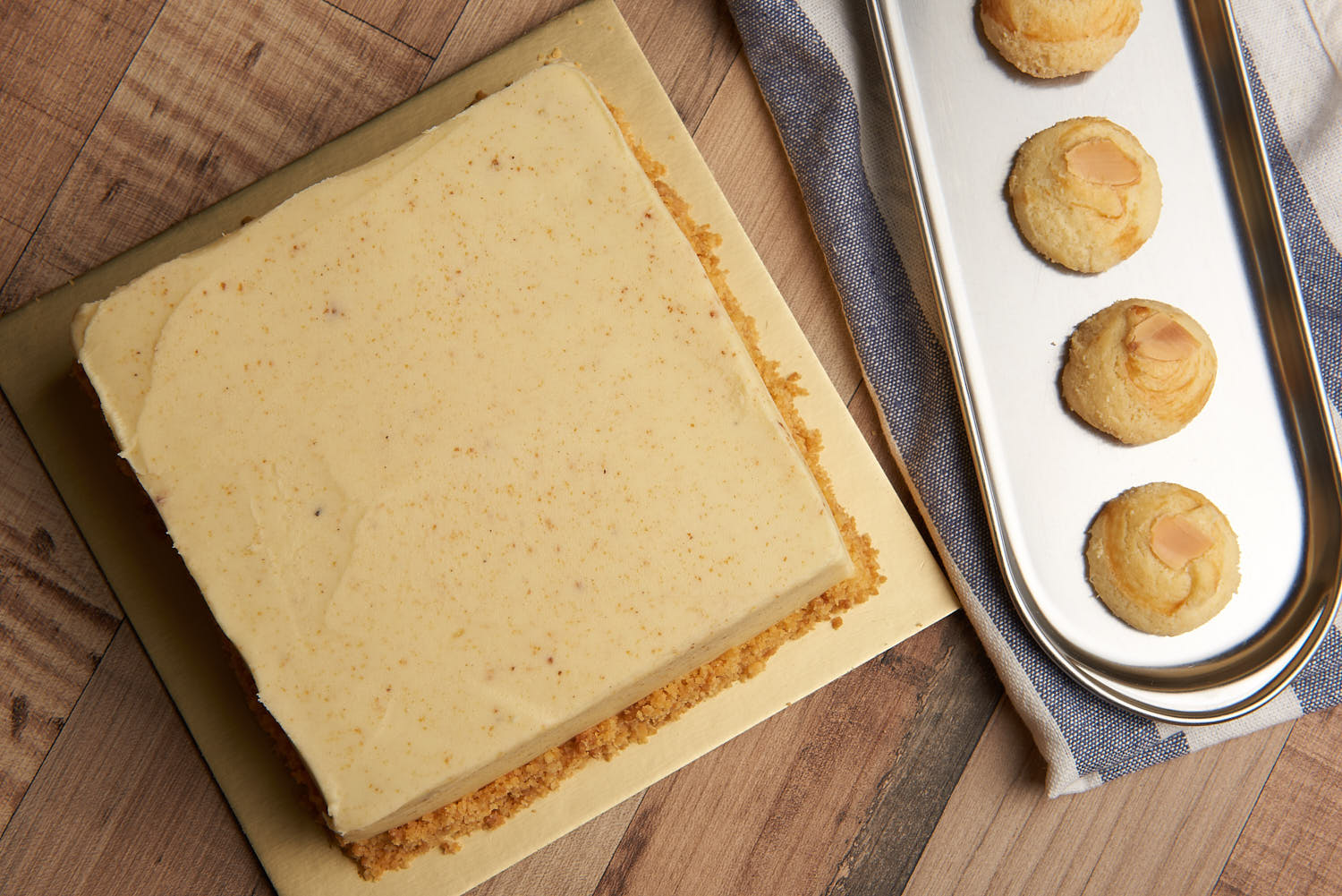 Assorted Sinpopo cake and cookies arranged on a rustic wooden board.