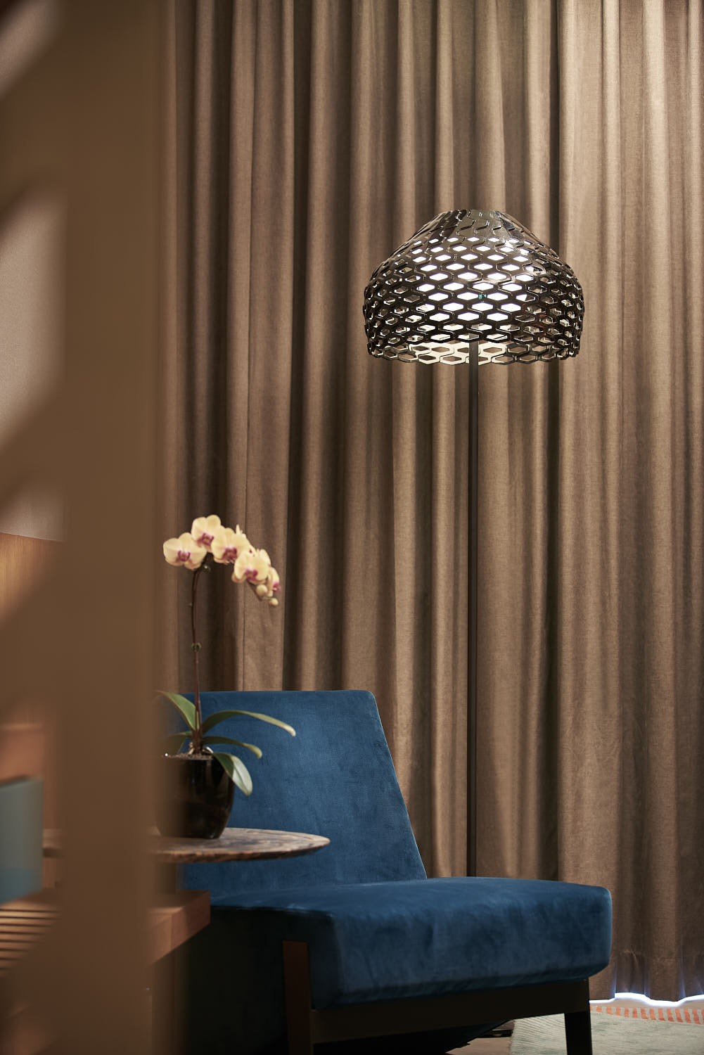 Close-up of a modern sofa chair in a guest room at Oasia Hotel.