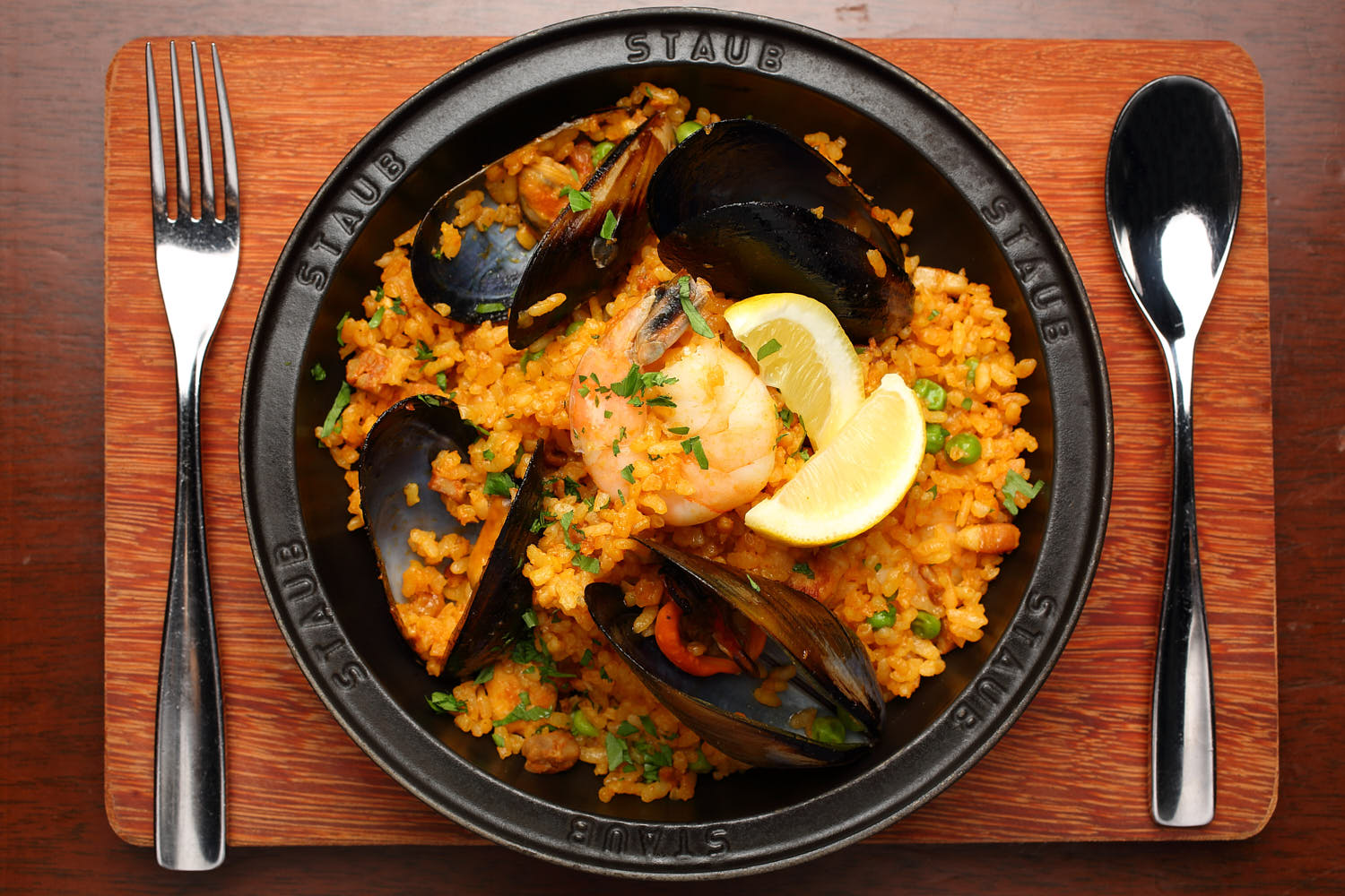 Traditional Spanish paella with saffron rice, seafood, and colorful vegetables.