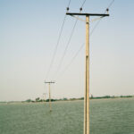 Electrical cables leading to a village submerged underwater in Sujawal, Pakistan, August 2010.