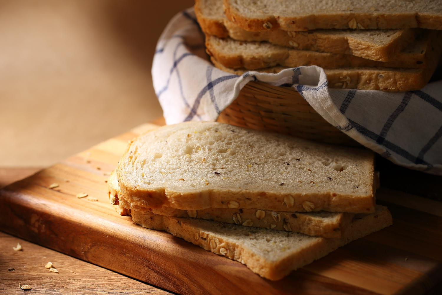 Freshly baked Supernature bread sliced on a wooden board.