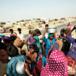 Local aid workers distributing water to flood victims in Thatta, Pakistan, August 2010.