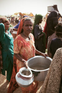 A woman expressing the struggle of insufficient resources for her family in Thatta, Pakistan, August 2010.