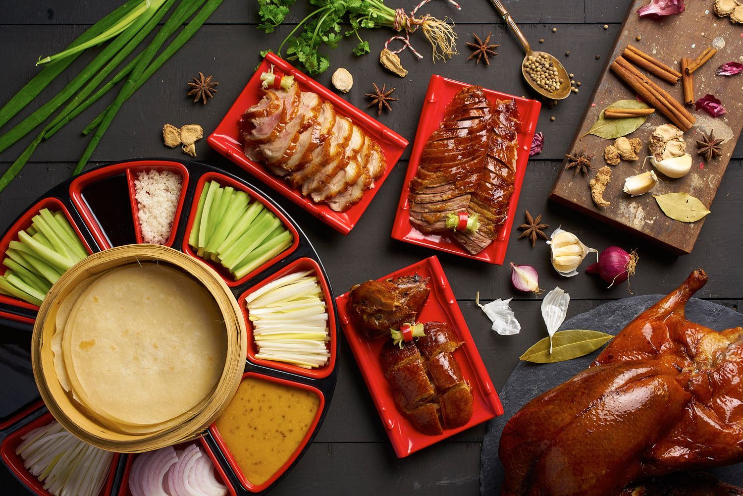 Tung Lok Peking Duck set beautifully arranged on a rustic wooden table with traditional sides.