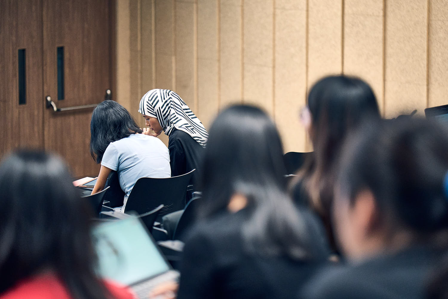 Group of university students collaborating and brainstorming ideas for a project.