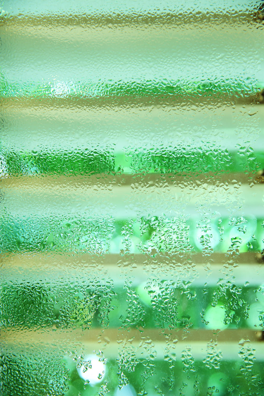 Close-up of a vintage colonial window with morning dew droplets.