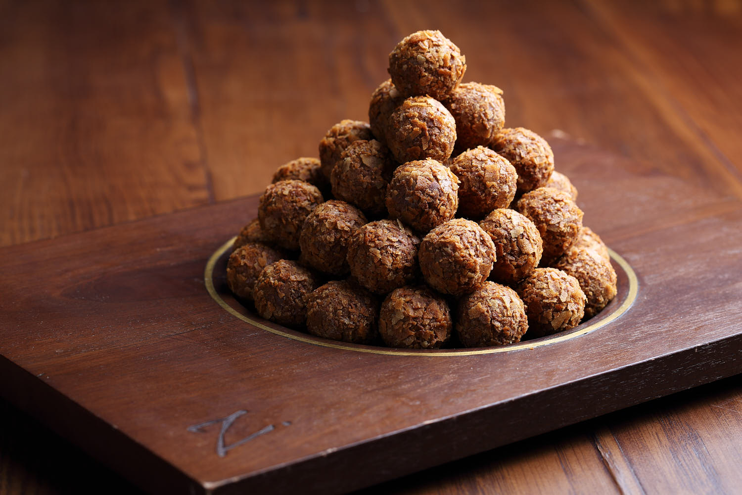 A mountain of rich chocolate truffles stacked artfully, dusted with cocoa flakes.